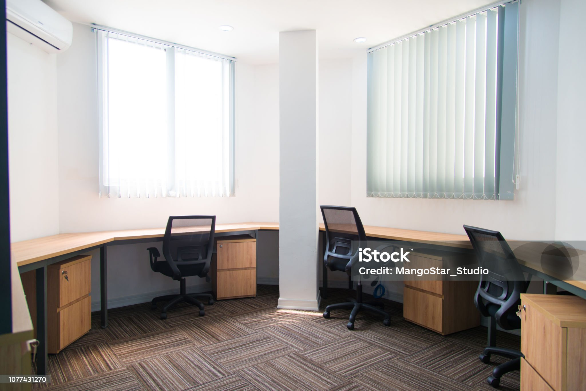 Small office with wooden table and stands near wall. Modern semicircular room with furniture. Office rent concept