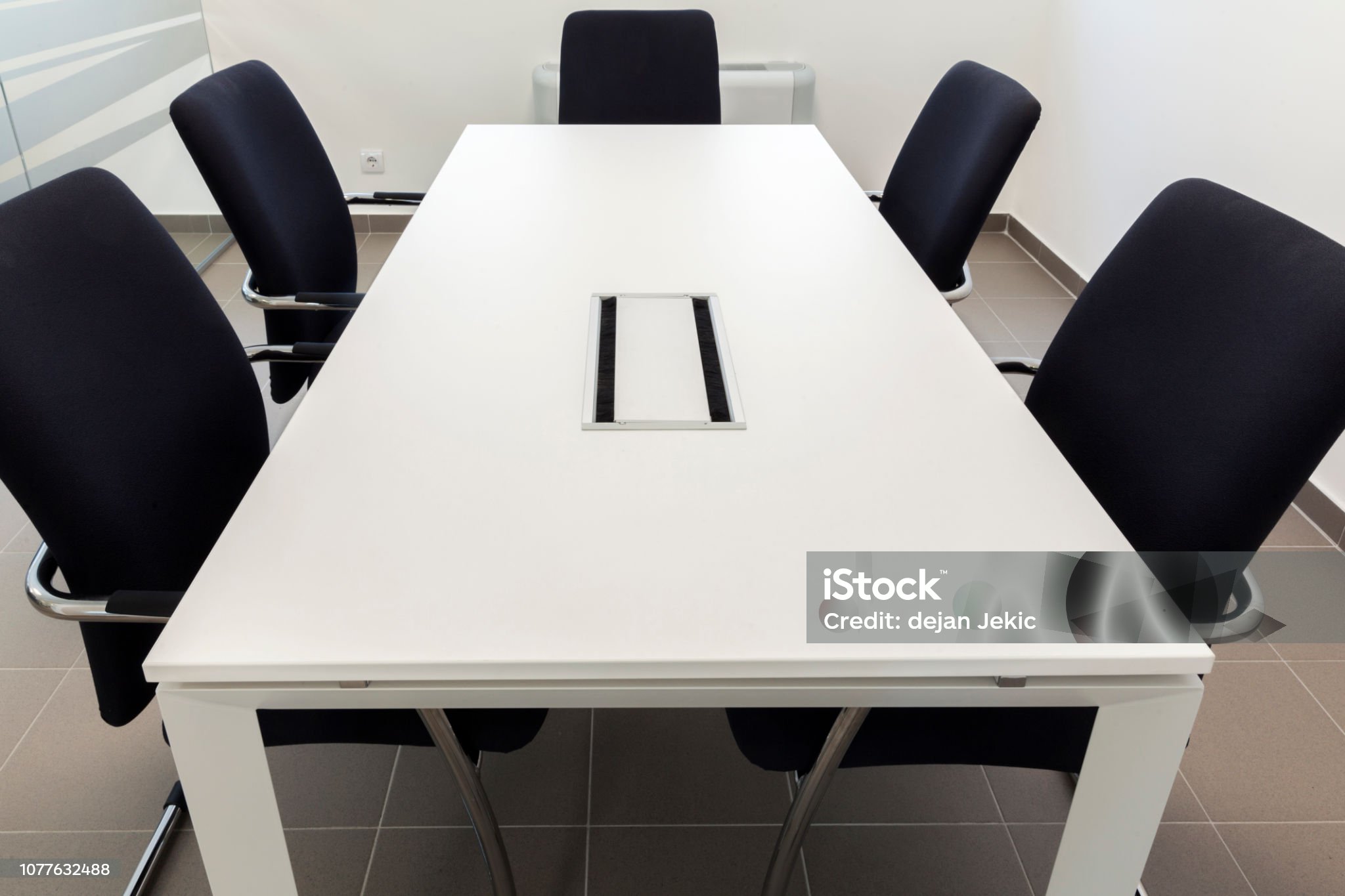 small conference room, white table and black chairs